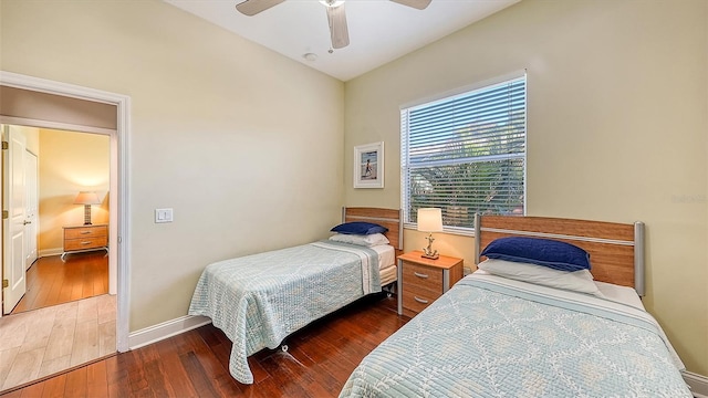 bedroom with ceiling fan, dark hardwood / wood-style floors, and vaulted ceiling