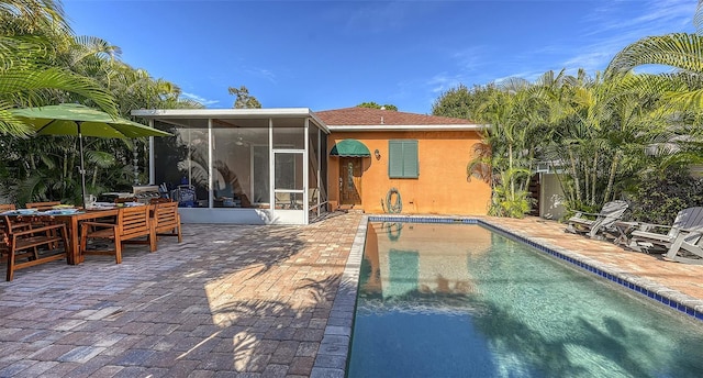 rear view of house with a patio and a sunroom