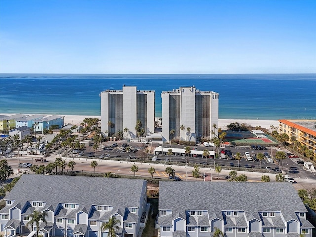 birds eye view of property featuring a water view and a beach view