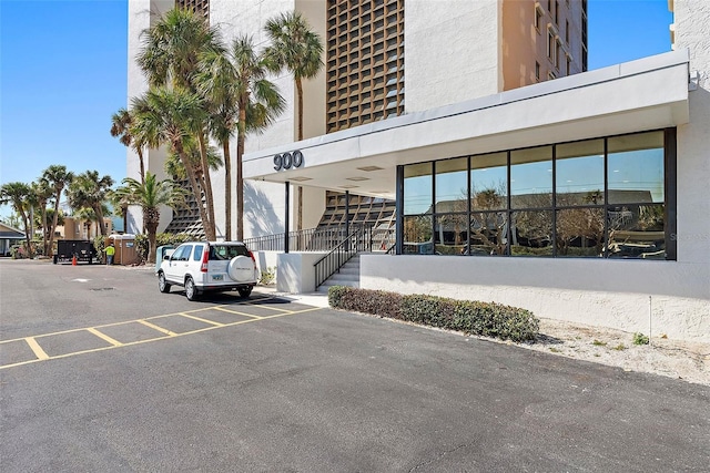 exterior space featuring stairs and uncovered parking