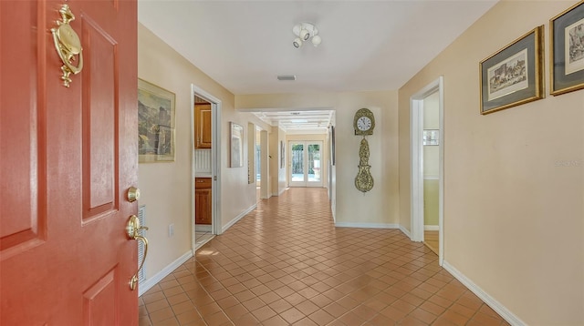 hall with light tile patterned flooring