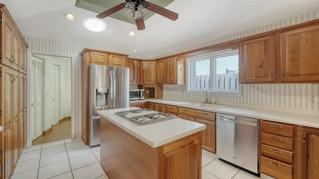 kitchen featuring stainless steel appliances, light tile patterned flooring, a center island, and sink