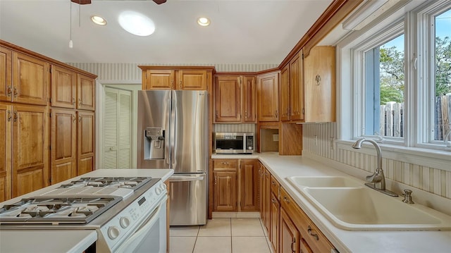 kitchen featuring sink, light tile patterned floors, and stainless steel appliances