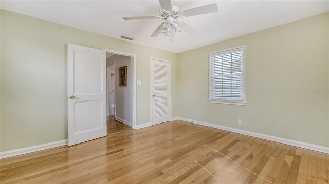 empty room featuring ceiling fan and light wood-type flooring