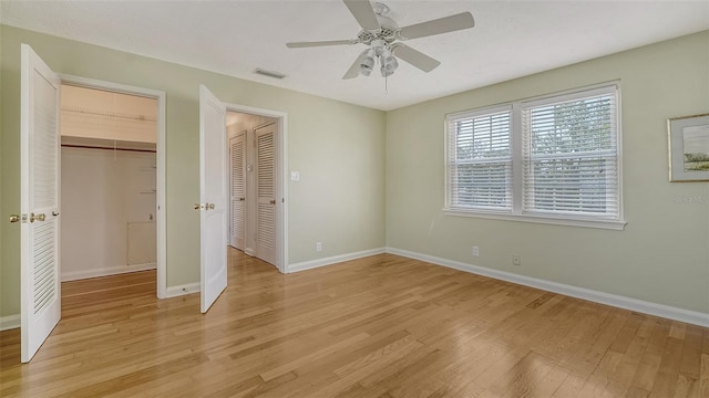 unfurnished bedroom with ceiling fan and light wood-type flooring