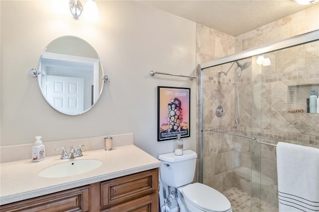 bathroom featuring vanity, walk in shower, and toilet