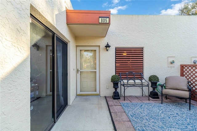 entrance to property featuring a patio