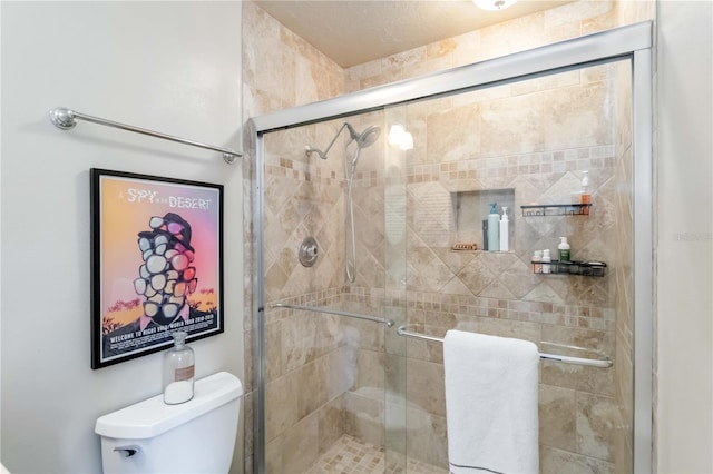 bathroom with an enclosed shower and toilet