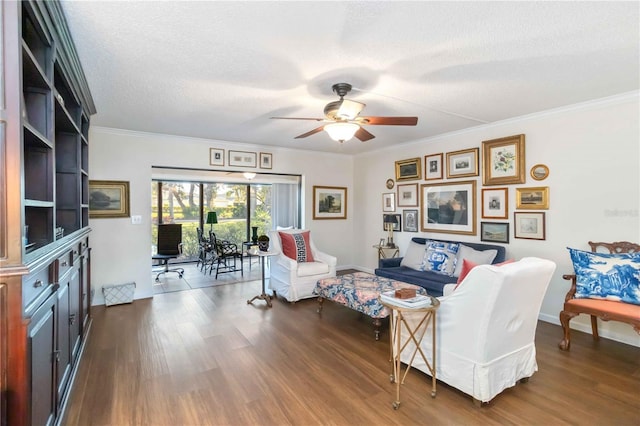 living room featuring ceiling fan, dark wood-type flooring, ornamental molding, and a textured ceiling