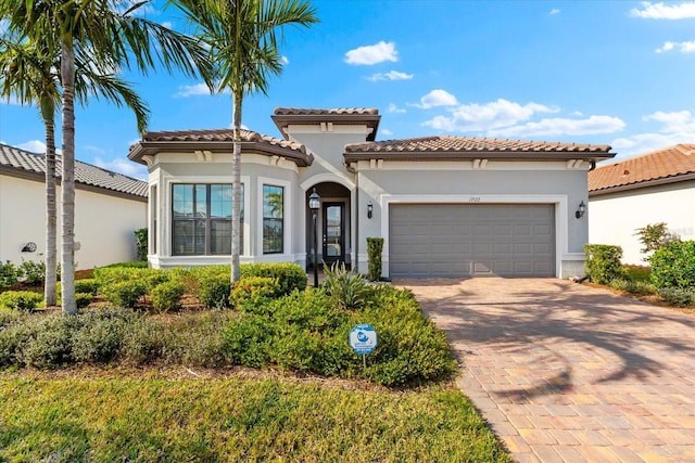 mediterranean / spanish-style home with a garage