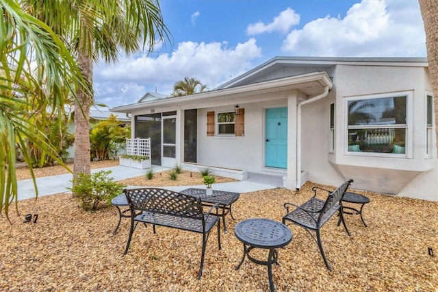 back of house with a sunroom