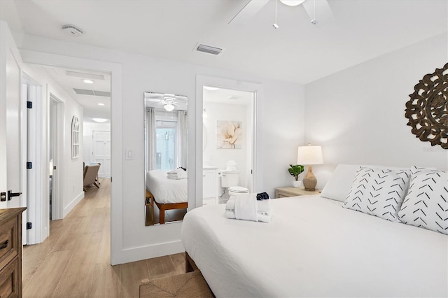 bedroom featuring ceiling fan, light wood-type flooring, and ensuite bath