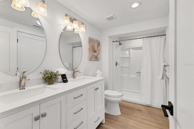 bathroom featuring vanity, hardwood / wood-style floors, curtained shower, and toilet