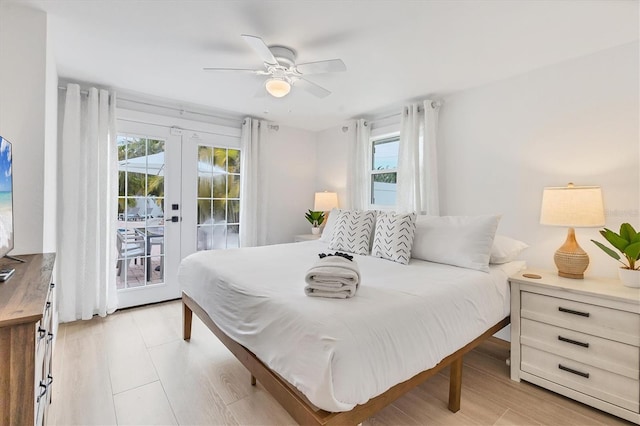 bedroom with access to outside, light hardwood / wood-style floors, french doors, and ceiling fan