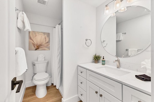 bathroom with vanity, hardwood / wood-style floors, and toilet