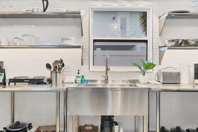 kitchen featuring tasteful backsplash and sink