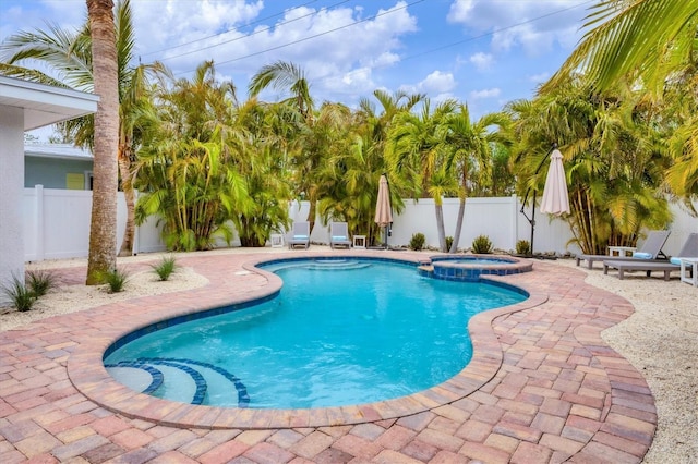 view of swimming pool with an in ground hot tub and a patio