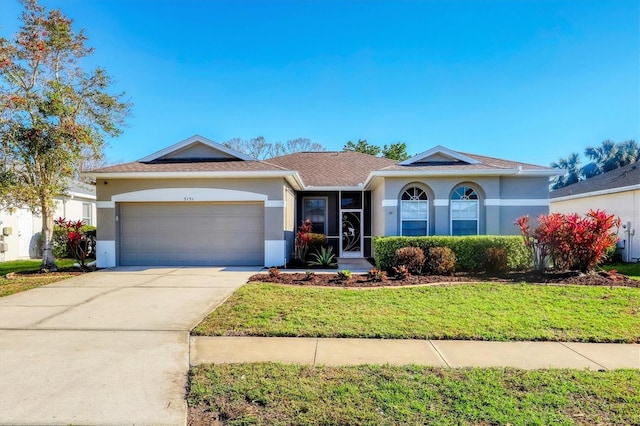 ranch-style house featuring a garage and a front yard