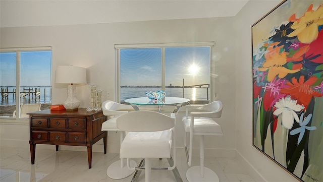 dining space featuring a water view