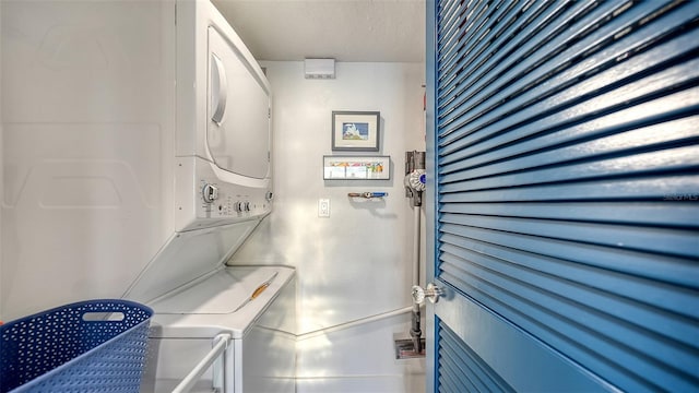 laundry room featuring stacked washing maching and dryer