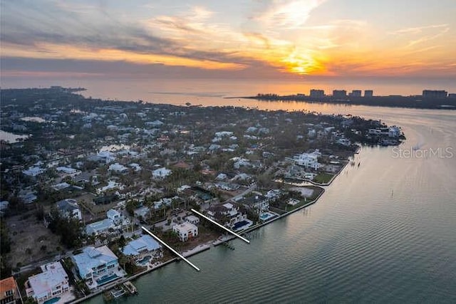 aerial view at dusk with a water view