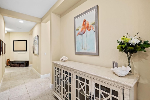 hall featuring light tile patterned floors