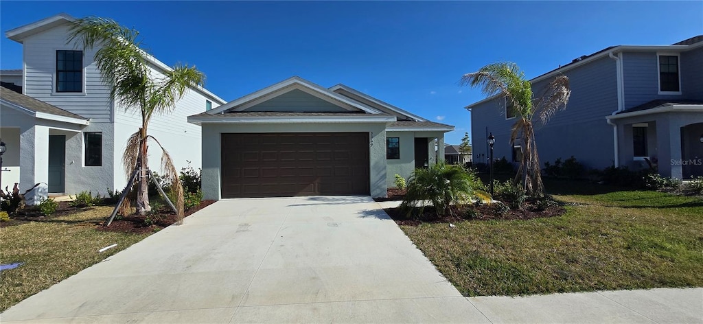 view of front of house featuring a garage and a front lawn