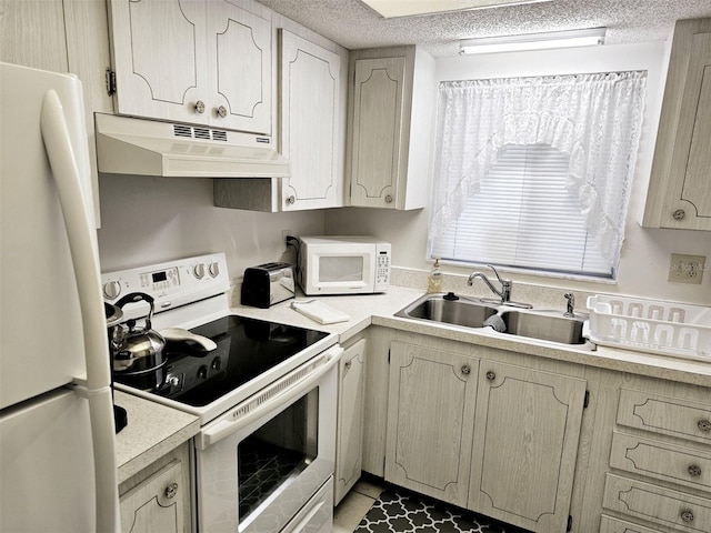 kitchen with sink, a textured ceiling, and white appliances