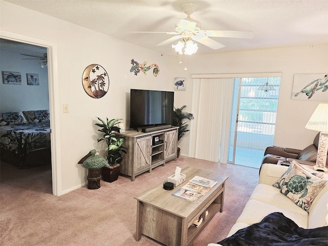 living room with light carpet, ceiling fan, and a textured ceiling