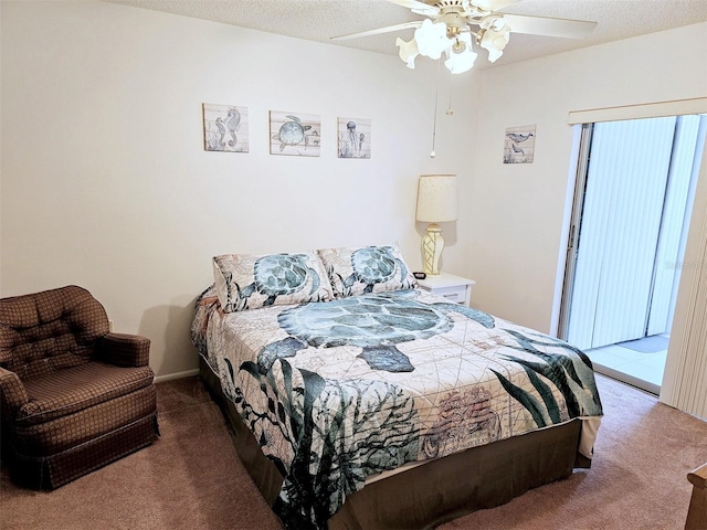 carpeted bedroom featuring ceiling fan and a textured ceiling