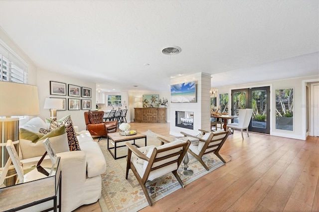 living room with a wealth of natural light and light hardwood / wood-style floors