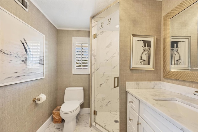 bathroom with crown molding, vanity, toilet, and a shower with shower door