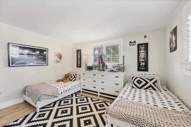 bedroom with hardwood / wood-style flooring and ornamental molding