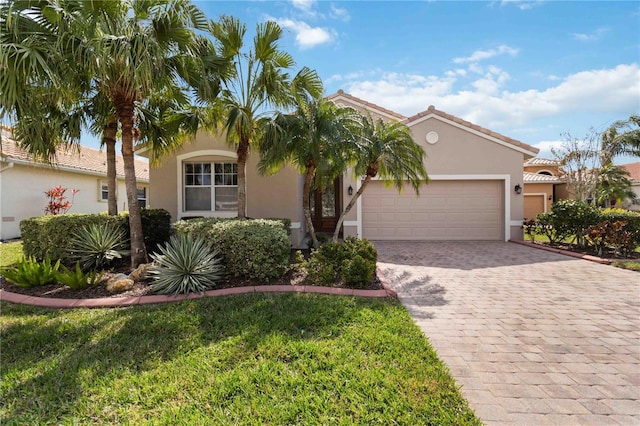 mediterranean / spanish-style home with a garage and a front yard