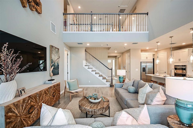 living room featuring a high ceiling and hardwood / wood-style floors