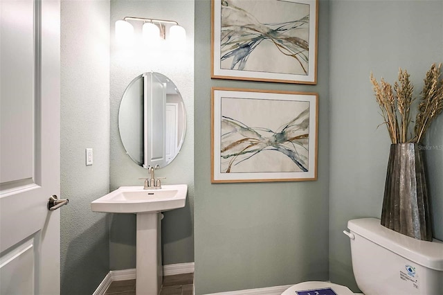 bathroom with hardwood / wood-style floors and toilet