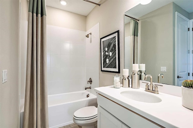 full bathroom with shower / tub combo with curtain, vanity, and toilet