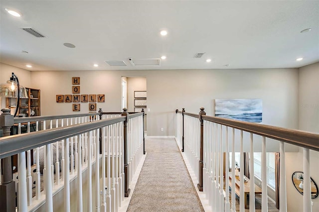 hallway featuring light colored carpet