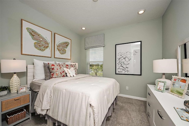 bedroom featuring light carpet and a textured ceiling