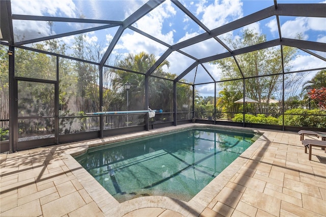 outdoor pool featuring a patio area and a lanai