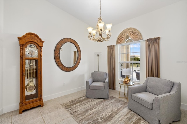 living area with lofted ceiling, an inviting chandelier, and baseboards