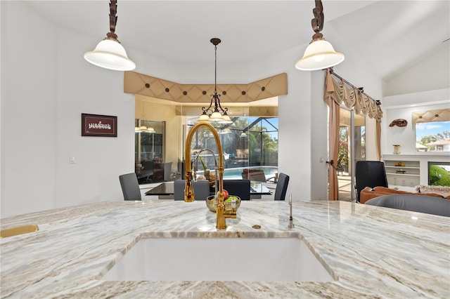 dining room featuring a sunroom and vaulted ceiling