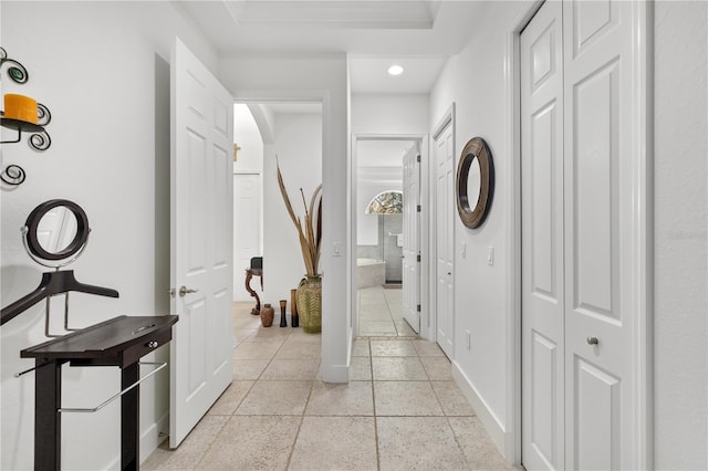 hallway featuring recessed lighting and baseboards