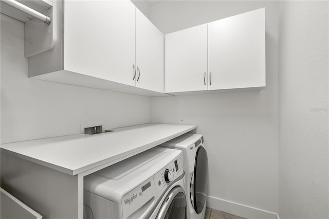 washroom featuring cabinet space, independent washer and dryer, and baseboards