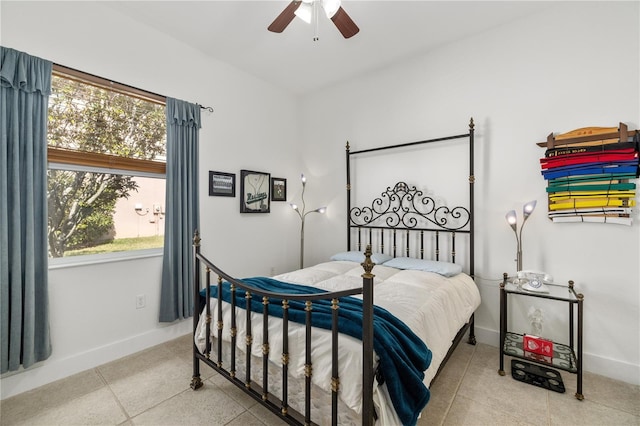 bedroom with multiple windows, ceiling fan, baseboards, and tile patterned floors