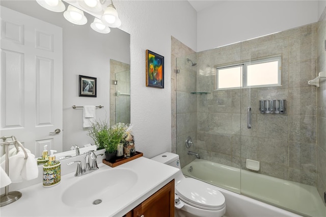 bathroom featuring toilet, enclosed tub / shower combo, a notable chandelier, and vanity