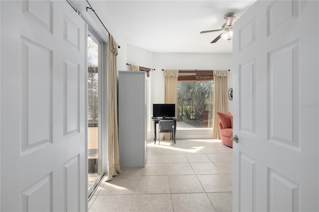 foyer with ceiling fan and light tile patterned floors