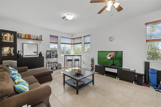 living room featuring ceiling fan, visible vents, and light tile patterned flooring