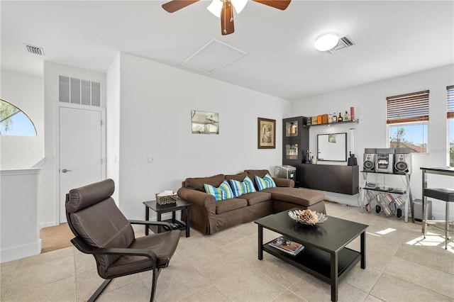 living area with visible vents, light tile patterned floors, and attic access