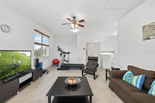 living room with light tile patterned floors, baseboards, and a ceiling fan